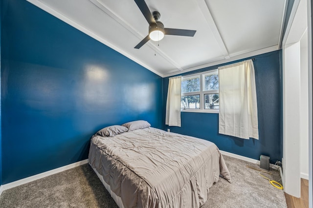 carpeted bedroom featuring baseboards, lofted ceiling with beams, and ceiling fan