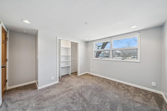 unfurnished bedroom with baseboards, recessed lighting, carpet, and a closet