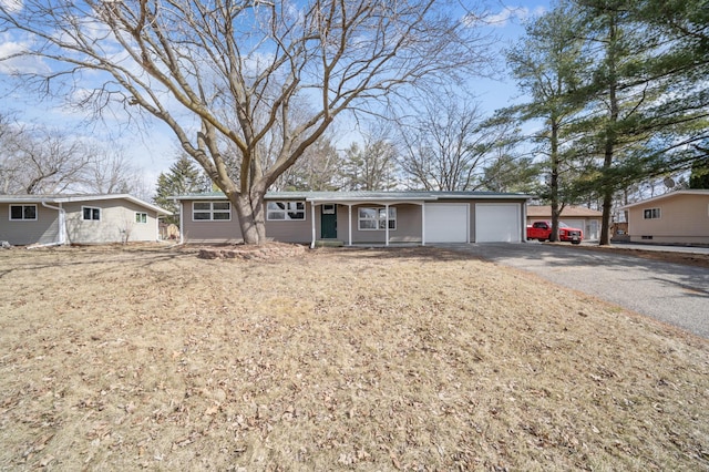 ranch-style home featuring an attached garage and driveway