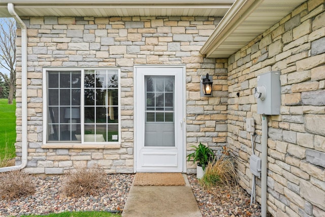 entrance to property featuring stone siding