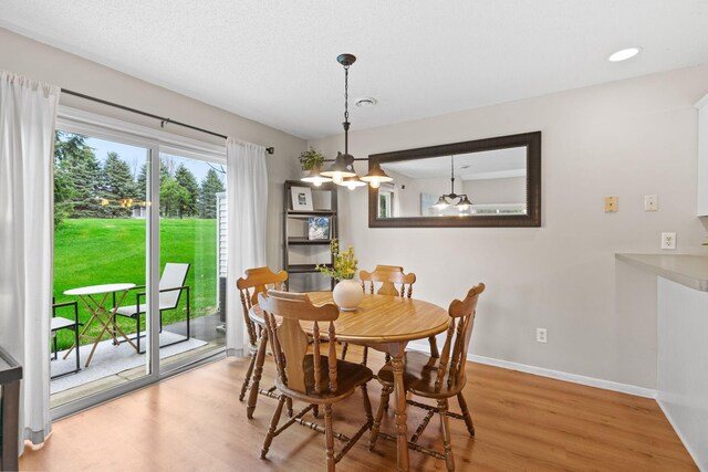 dining space featuring baseboards and wood finished floors