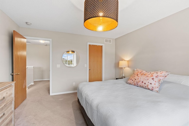 bedroom with baseboards, light colored carpet, and visible vents