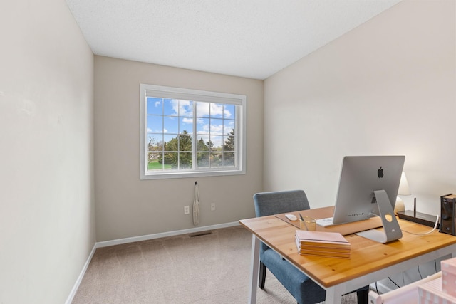 carpeted office space featuring baseboards and visible vents