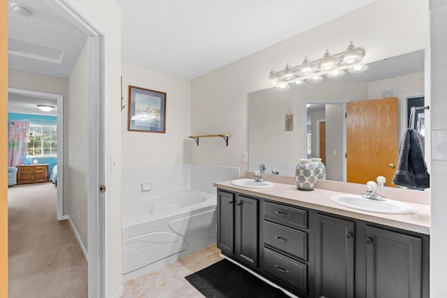 full bath featuring a garden tub, a sink, connected bathroom, and double vanity