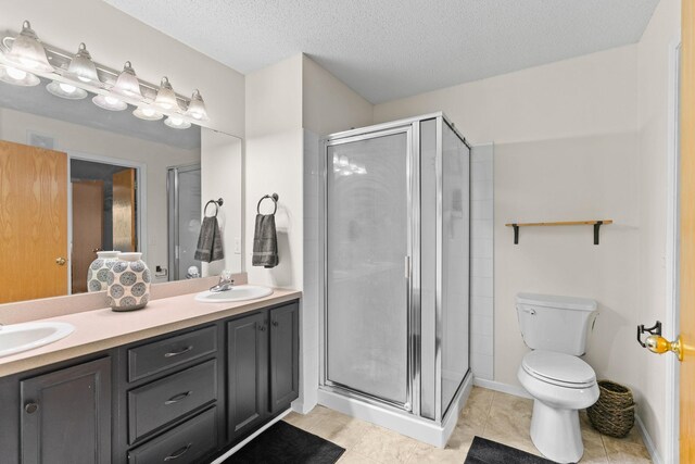 full bathroom with a sink, a stall shower, and toilet