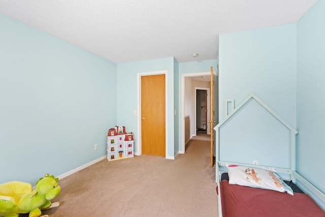 playroom featuring baseboards and light carpet