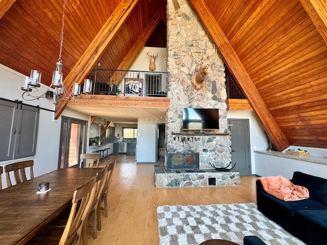 63521 County Road 2, Warroad, MN 56763 - living room featuring a notable chandelier, wood-type flooring, high vaulted ceiling, wooden ceiling, and beamed ceiling