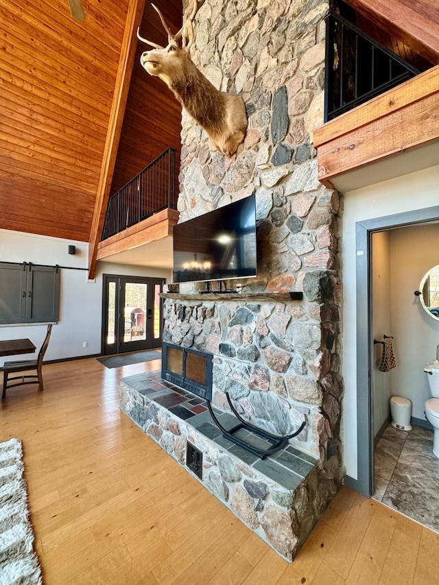 63521 County Road 2, Warroad, MN 56763 - living room featuring wooden ceiling, baseboards, hardwood / wood-style flooring, and high vaulted ceiling