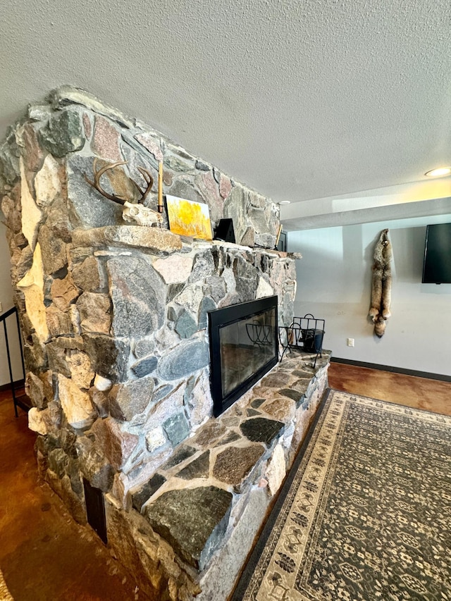 63521 County Road 2, Warroad, MN 56763 - living area with a stone fireplace, a textured ceiling, and baseboards
