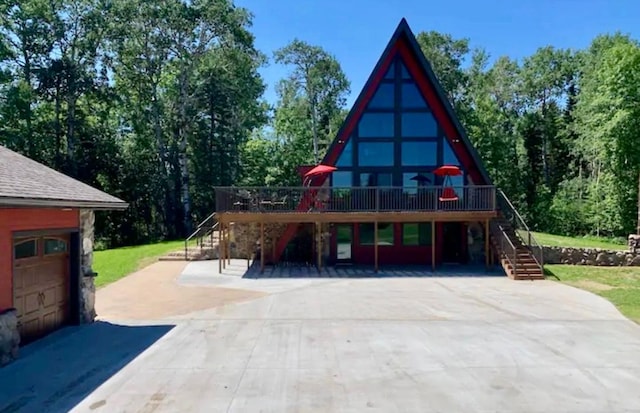 63521 County Road 2, Warroad, MN 56763 - rear view of house featuring driveway, stairway, and a deck