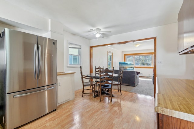 kitchen featuring freestanding refrigerator, plenty of natural light, white cabinets, and light wood-style floors