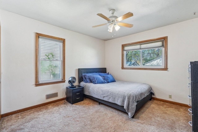 carpeted bedroom with baseboards and ceiling fan