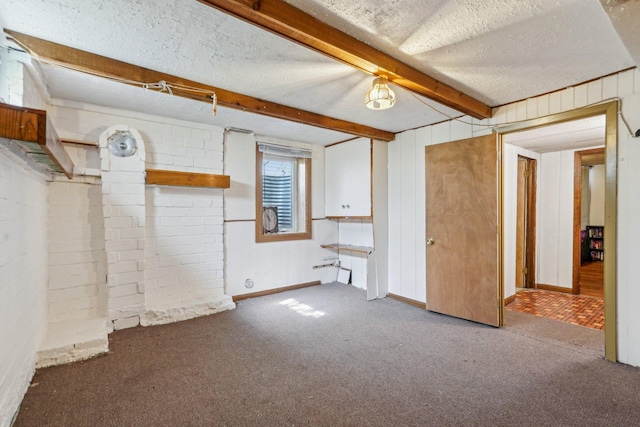 below grade area with carpet flooring and a textured ceiling