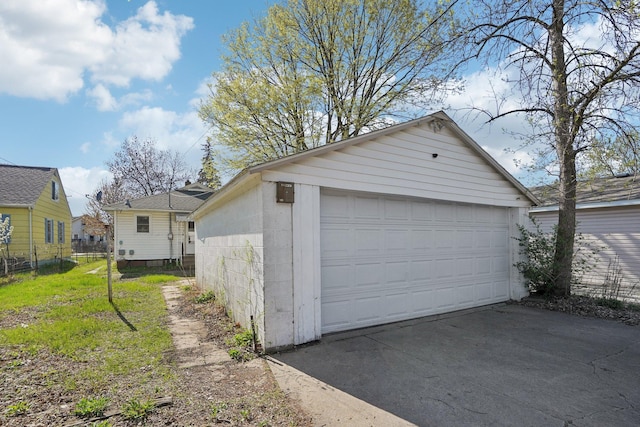 detached garage featuring fence