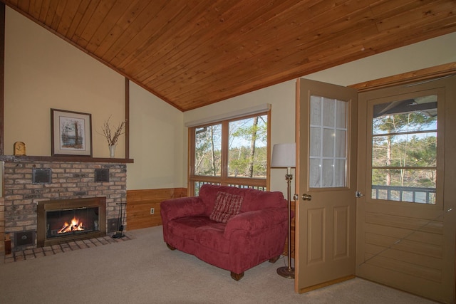 living area featuring wainscoting, healthy amount of natural light, carpet, lofted ceiling, and wood ceiling
