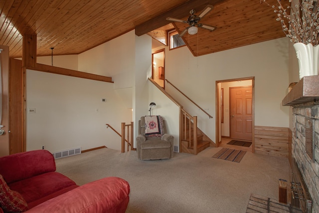 living room featuring wood ceiling, high vaulted ceiling, carpet floors, a ceiling fan, and a stone fireplace