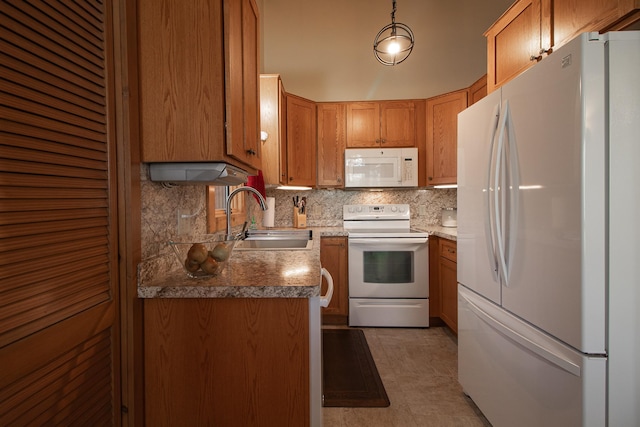kitchen with white appliances, a sink, backsplash, and brown cabinetry