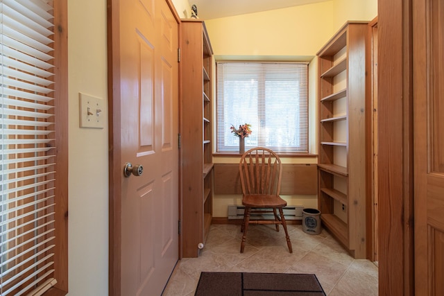 living area with a baseboard radiator and light tile patterned floors