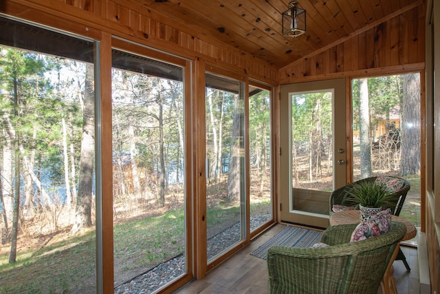 sunroom featuring vaulted ceiling
