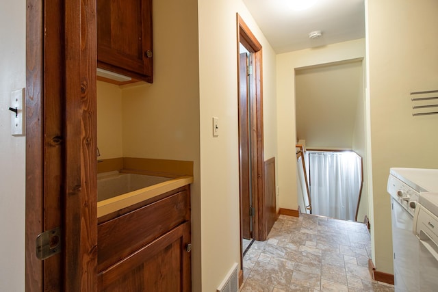 bathroom featuring stone finish flooring and baseboards