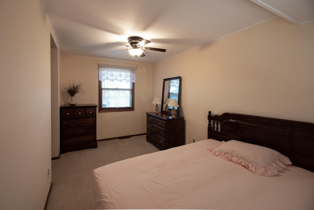 bedroom featuring light carpet, baseboards, and a ceiling fan