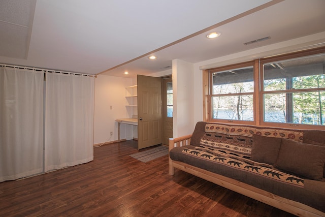 living area with dark wood finished floors, recessed lighting, and baseboards