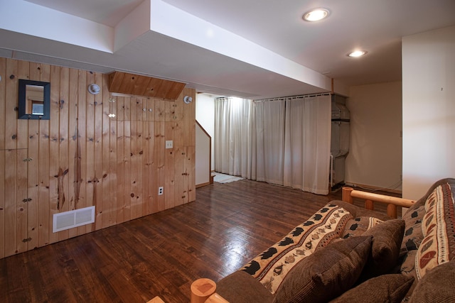 bedroom featuring wood finished floors, wood walls, and recessed lighting