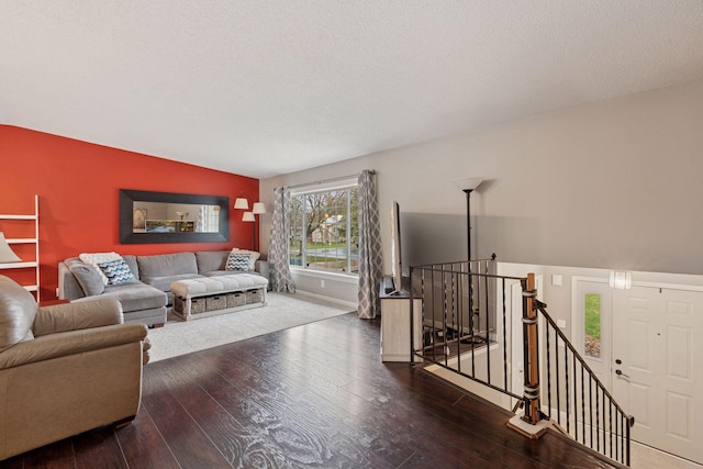living room with baseboards, vaulted ceiling, and hardwood / wood-style flooring
