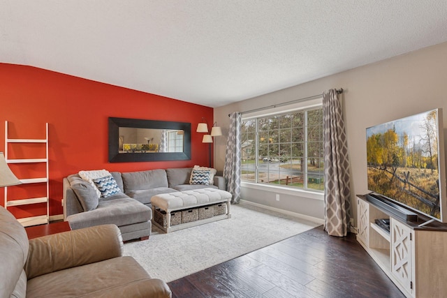 living area featuring a textured ceiling, baseboards, dark wood-style floors, and lofted ceiling