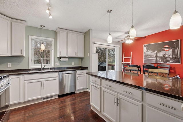 kitchen with a sink, appliances with stainless steel finishes, a ceiling fan, and a textured ceiling