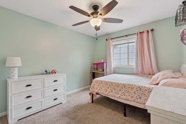 bedroom with baseboards, ceiling fan, and light carpet