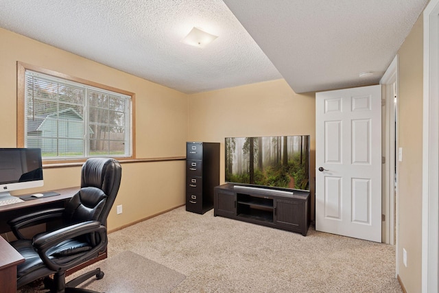 carpeted home office with baseboards and a textured ceiling