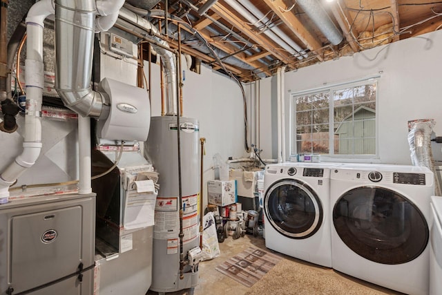 washroom featuring laundry area, a sink, independent washer and dryer, and water heater