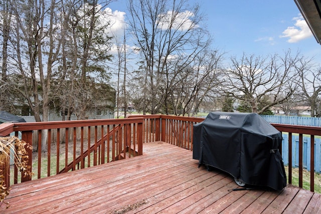 wooden deck featuring a grill