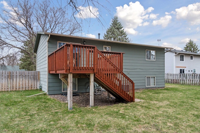 rear view of house with a lawn, a wooden deck, stairs, and a fenced backyard