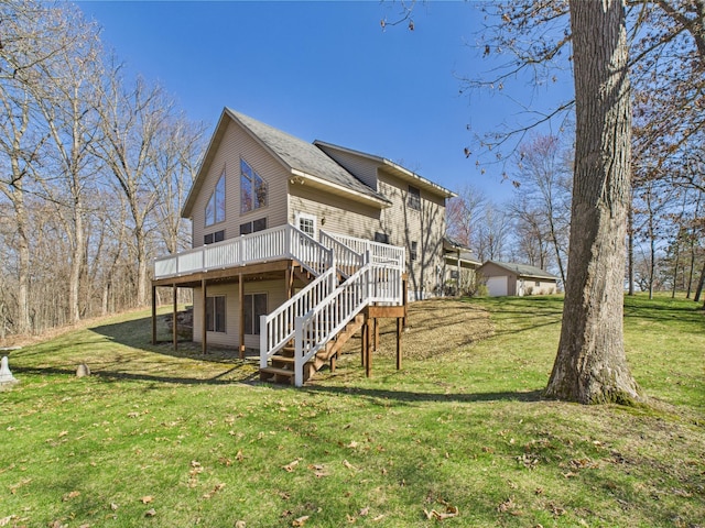rear view of property featuring a lawn, a wooden deck, and stairs
