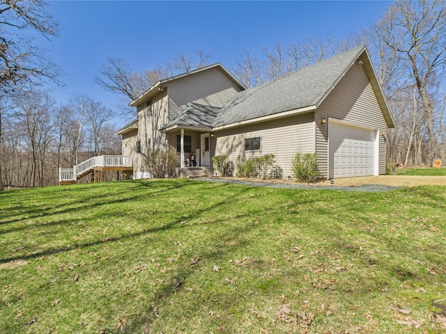 traditional-style house with an attached garage, a shingled roof, and a front yard