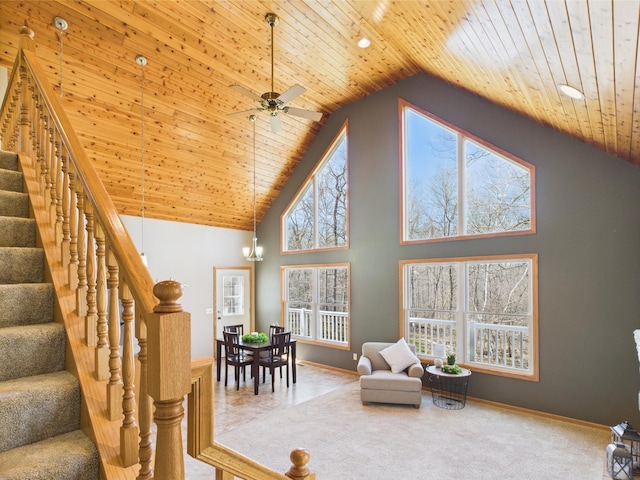 living room with stairs, a healthy amount of sunlight, wood ceiling, and carpet