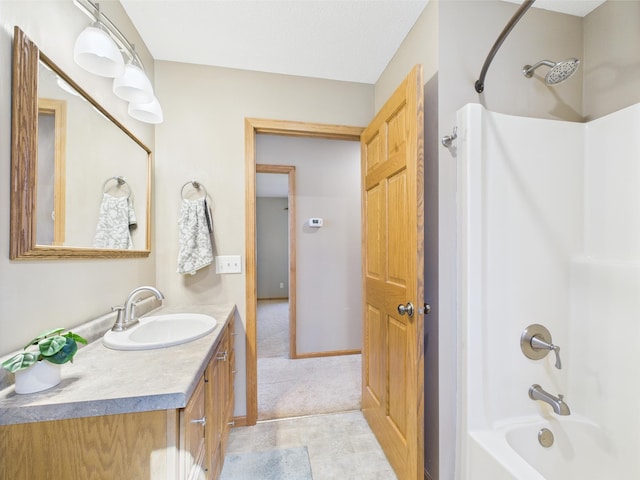 full bathroom featuring vanity, baseboards, and bathtub / shower combination