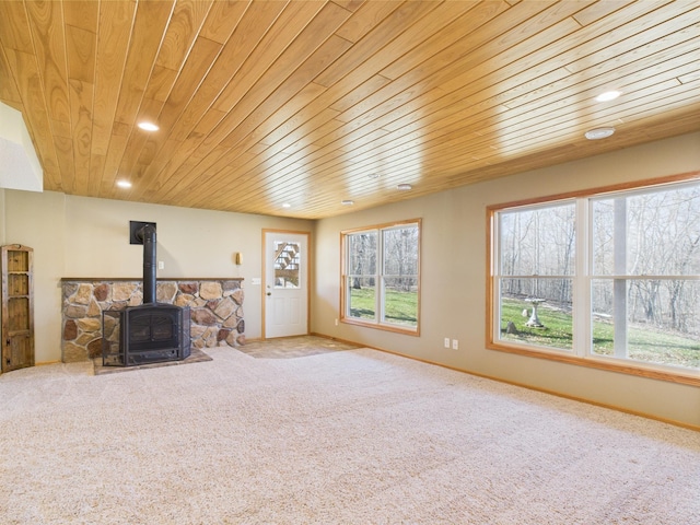 living room featuring wood ceiling, a wood stove, recessed lighting, and carpet floors