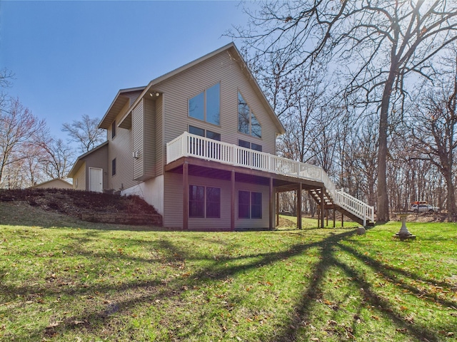 back of property featuring a wooden deck, a yard, and stairway