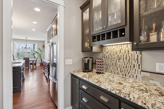 bar featuring dark wood-type flooring, recessed lighting, smart refrigerator, and backsplash