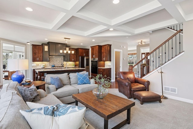 living room featuring visible vents, recessed lighting, and coffered ceiling