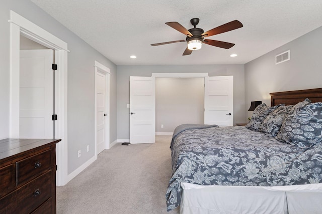 bedroom with visible vents, recessed lighting, baseboards, and light colored carpet