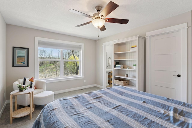 bedroom featuring baseboards, ceiling fan, carpet, and a textured ceiling
