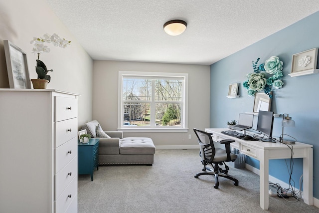 office with carpet floors, baseboards, and a textured ceiling