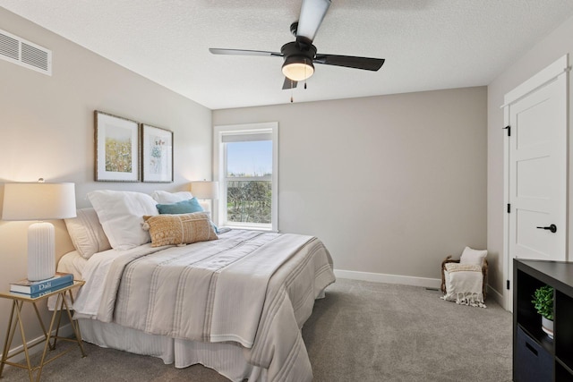 bedroom with a ceiling fan, a textured ceiling, visible vents, carpet floors, and baseboards