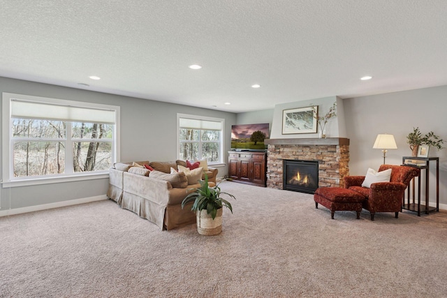 living room with recessed lighting, a textured ceiling, carpet, and a fireplace