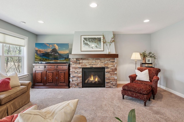 carpeted living area featuring recessed lighting, baseboards, and a fireplace