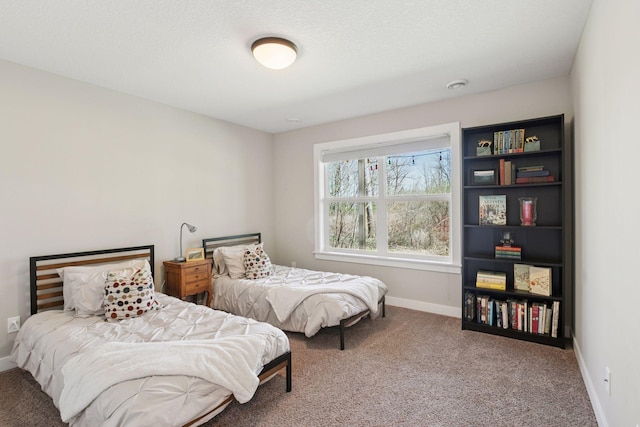 bedroom with baseboards and carpet